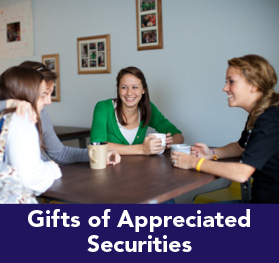 Rollover image of students at a table talking. Link to Gifts of Appreciated Securities.